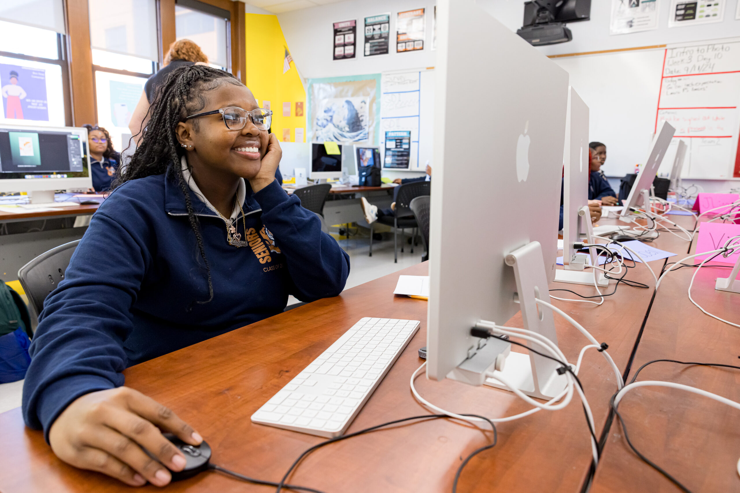 student smiling at computer