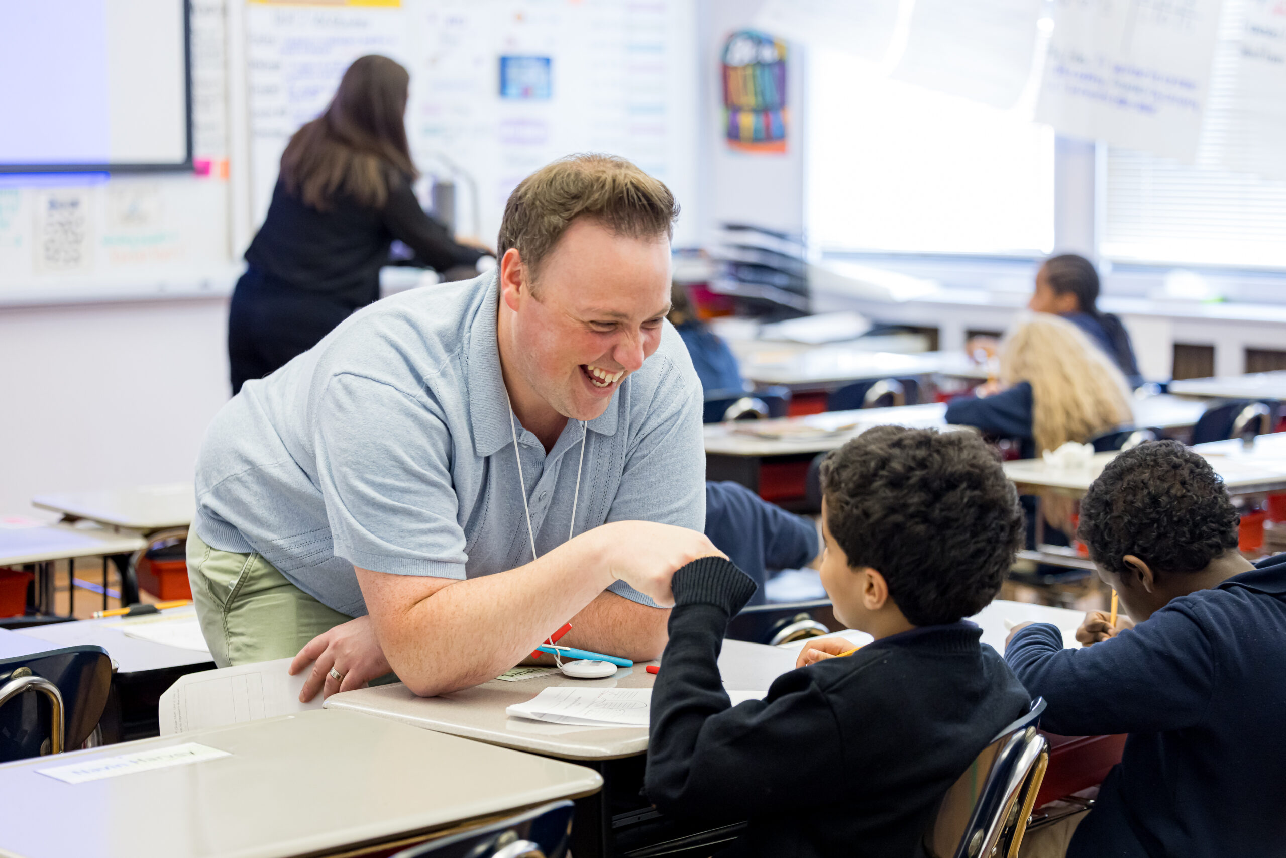 Teacher and student smiling classroom