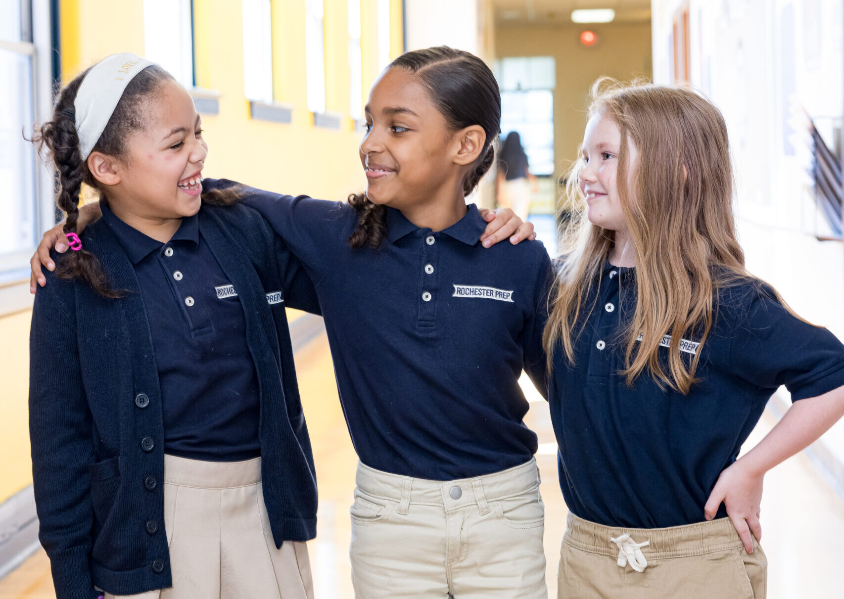 three students in a school hallway