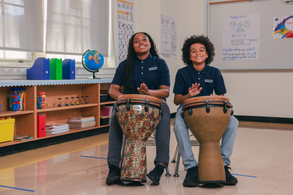 Two students playing drums